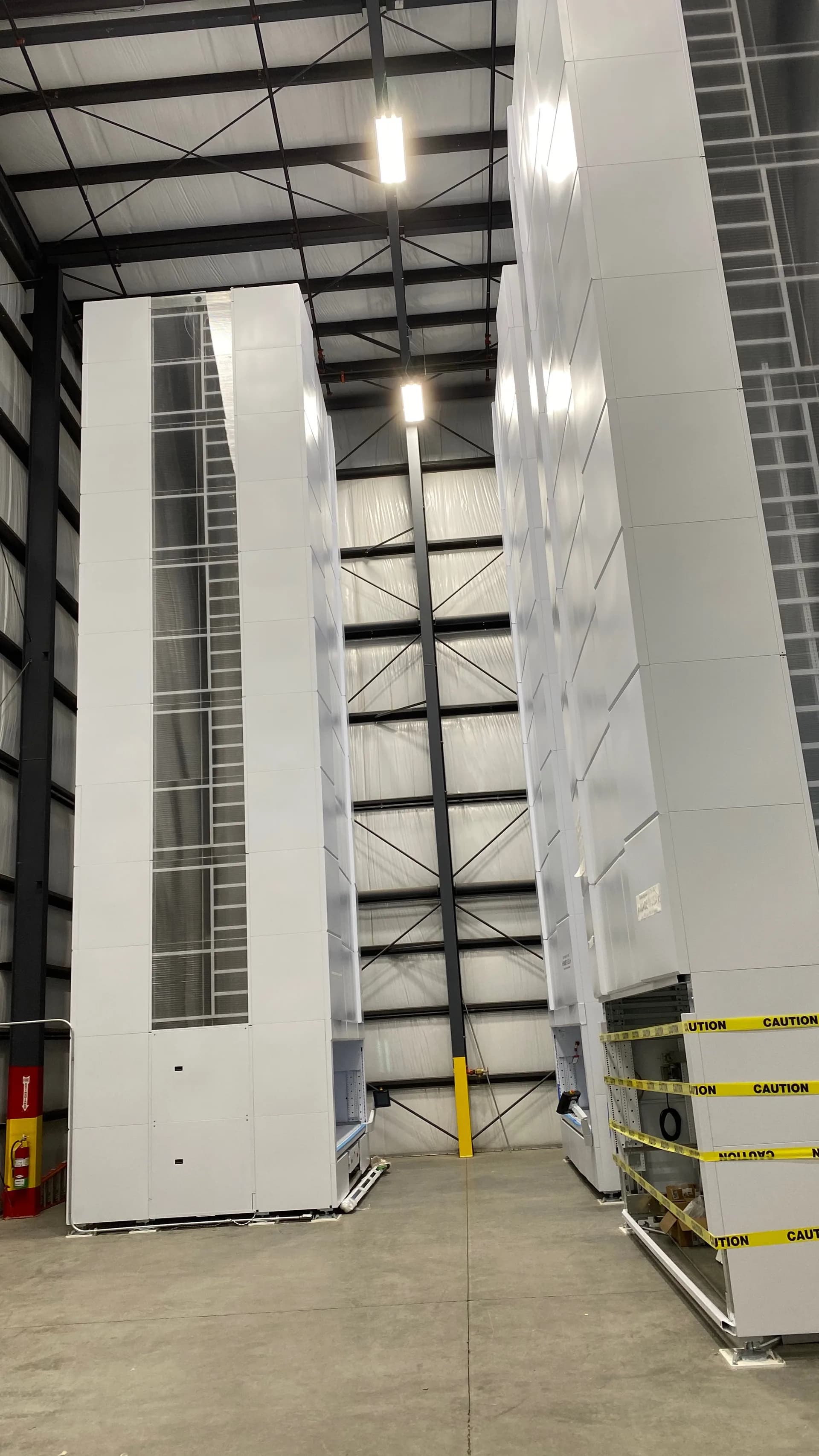 Vertical lift module tower installed in a warehouse